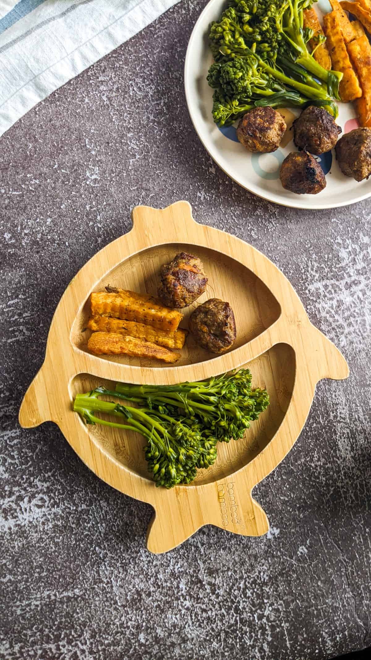 Beef meatballs served for baby and toddler with sweet potatoes and broccoli.