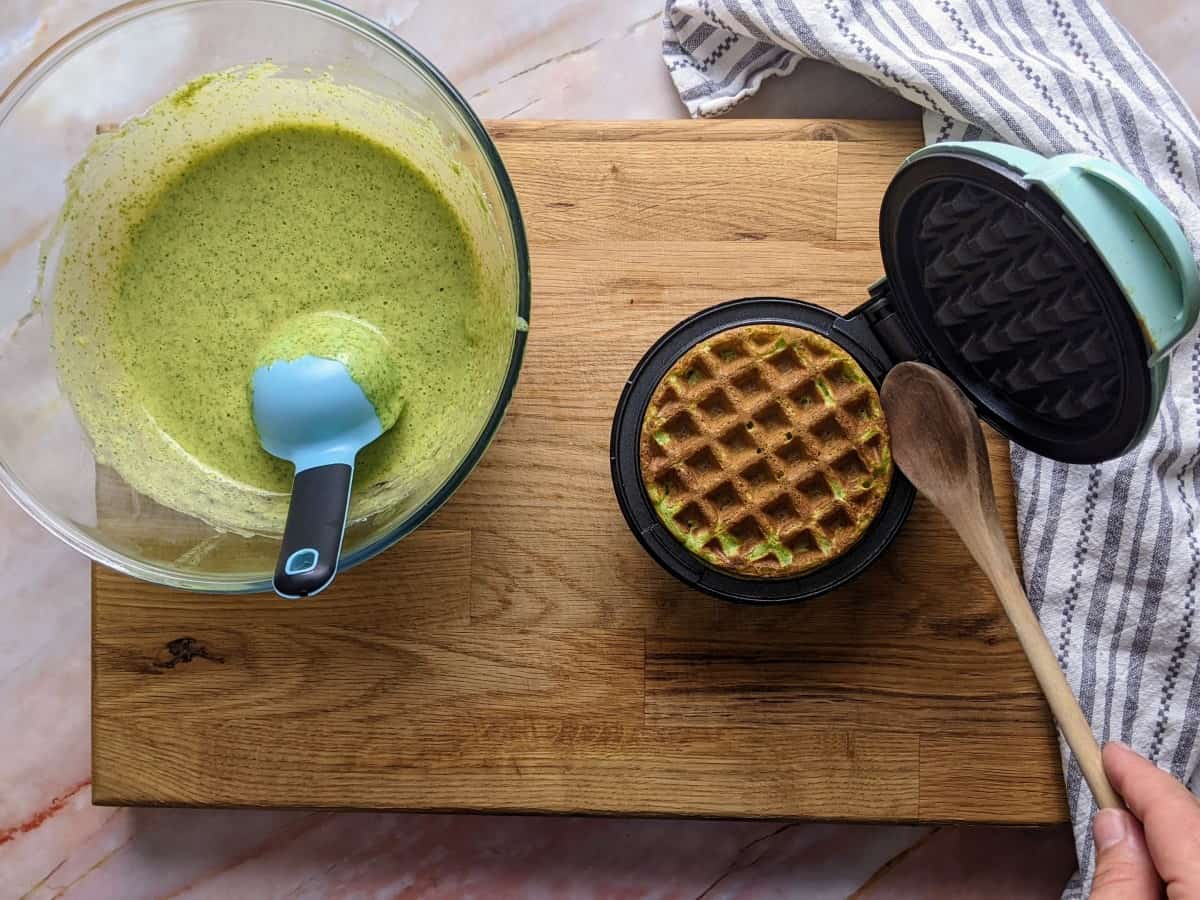Spinach waffle ready in the waffle maker.