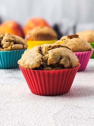 Sugar-free peach muffins in colorful muffin cases.