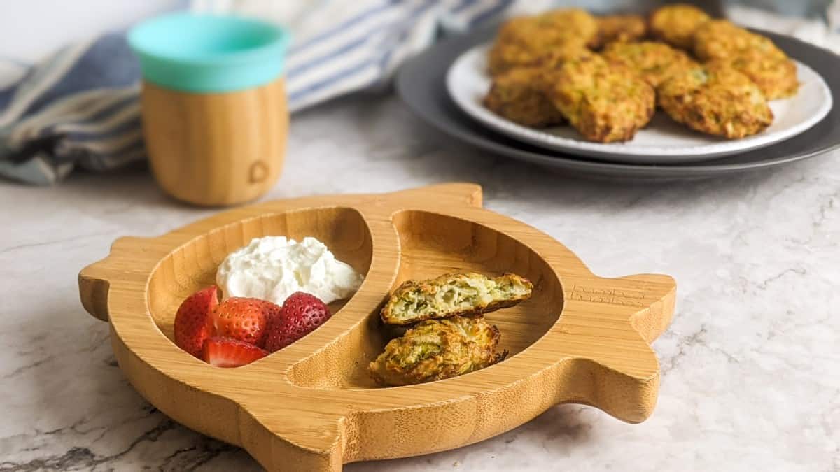 Zucchini fritters served in bamboo plate for a baby.