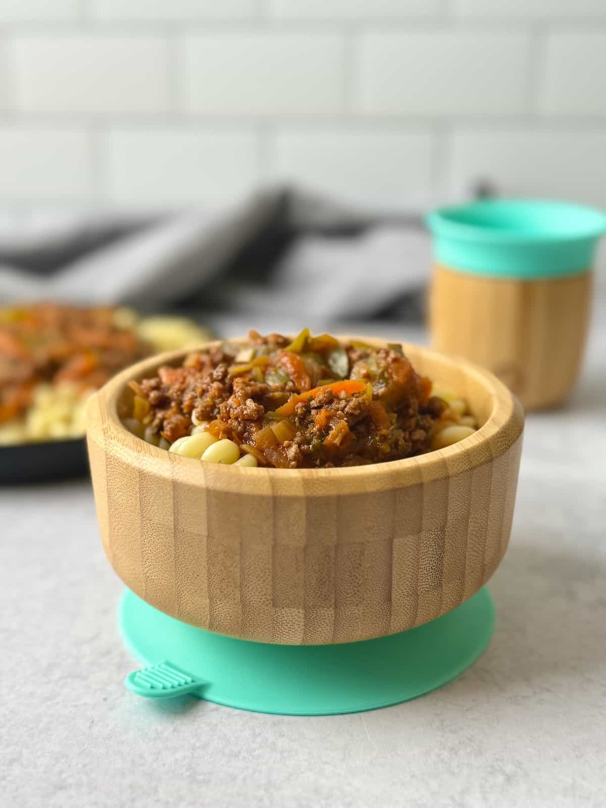 Veggie loaded pasta bolognese served in bamboo bowl for baby.