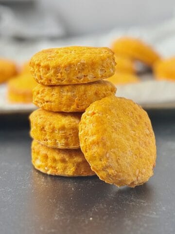 Sweet potatoes and cheese biscuits stack on top of each other, with one at the side.