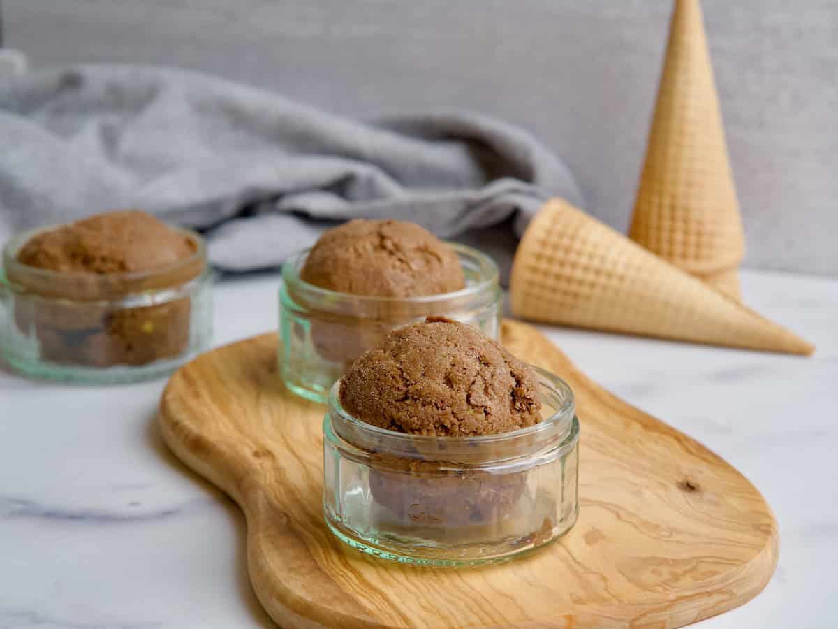 Served chocolate avocado ice cream in three glass bowls.