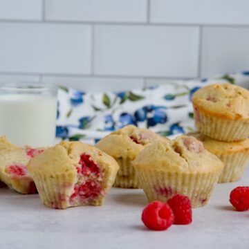 Raspberry banana muffins with a glass of milk.