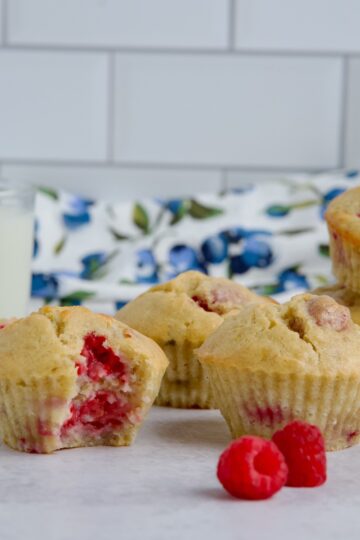 Raspberry banana muffins with a glass of milk.