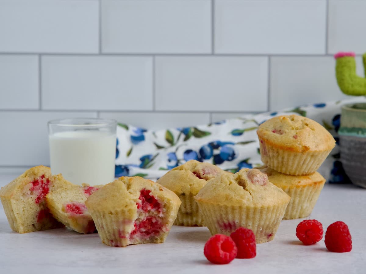Raspberry banana muffins with a glass of milk.
