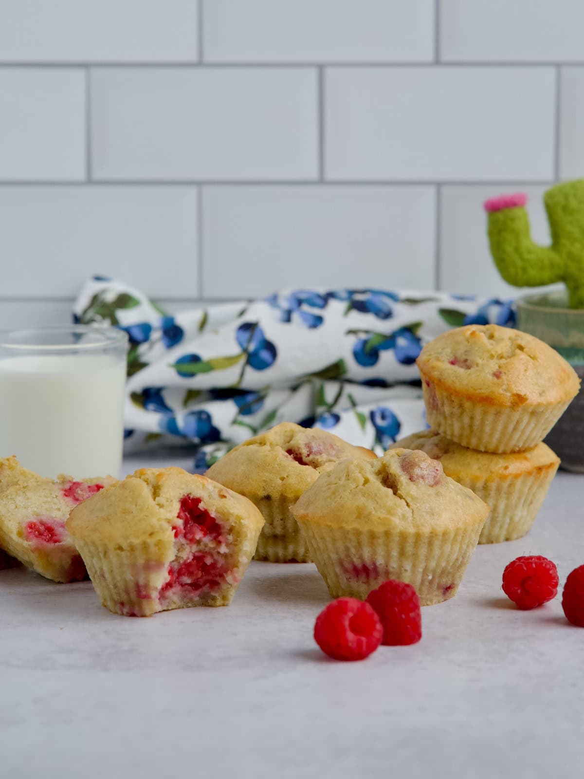 Raspberry banana muffins with a glass of milk.