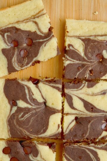 Marble chocolate sheetpan pancake cut into slices on a wooden board.
