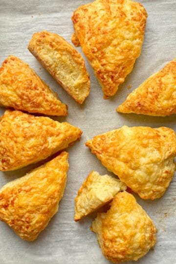 Cheese scones on a baking tray.