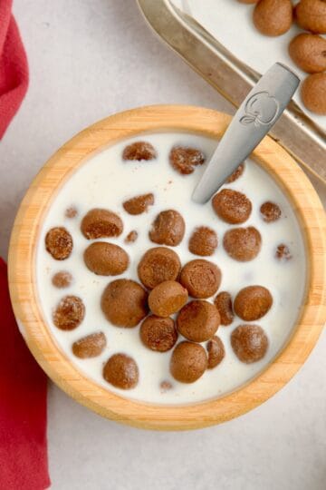 Cocoa puffs served in a bowl with milk.