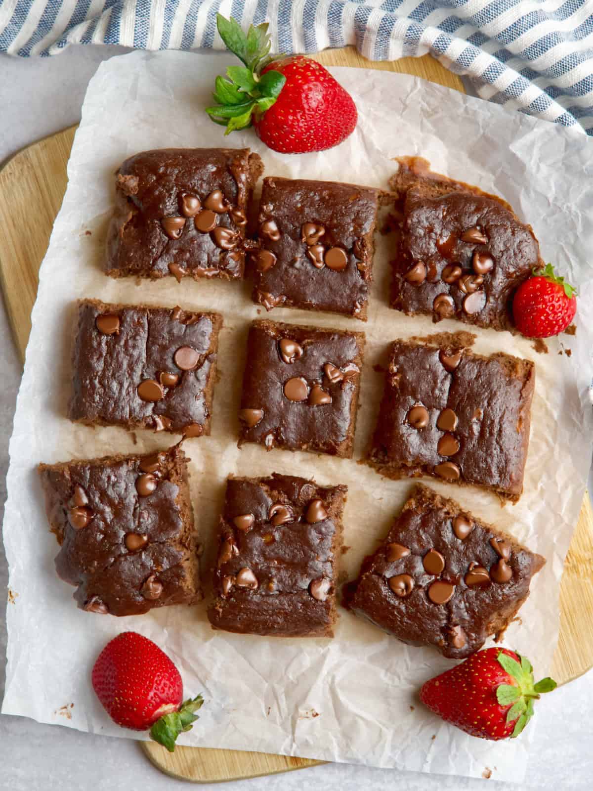 Chocolate squares slices with strawberries between them.