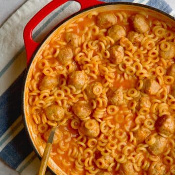 Spaghettios with meatballs in cast iron pan.