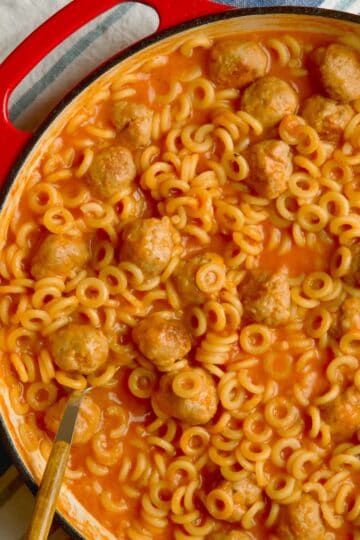 Spaghettios with meatballs in cast iron pan.