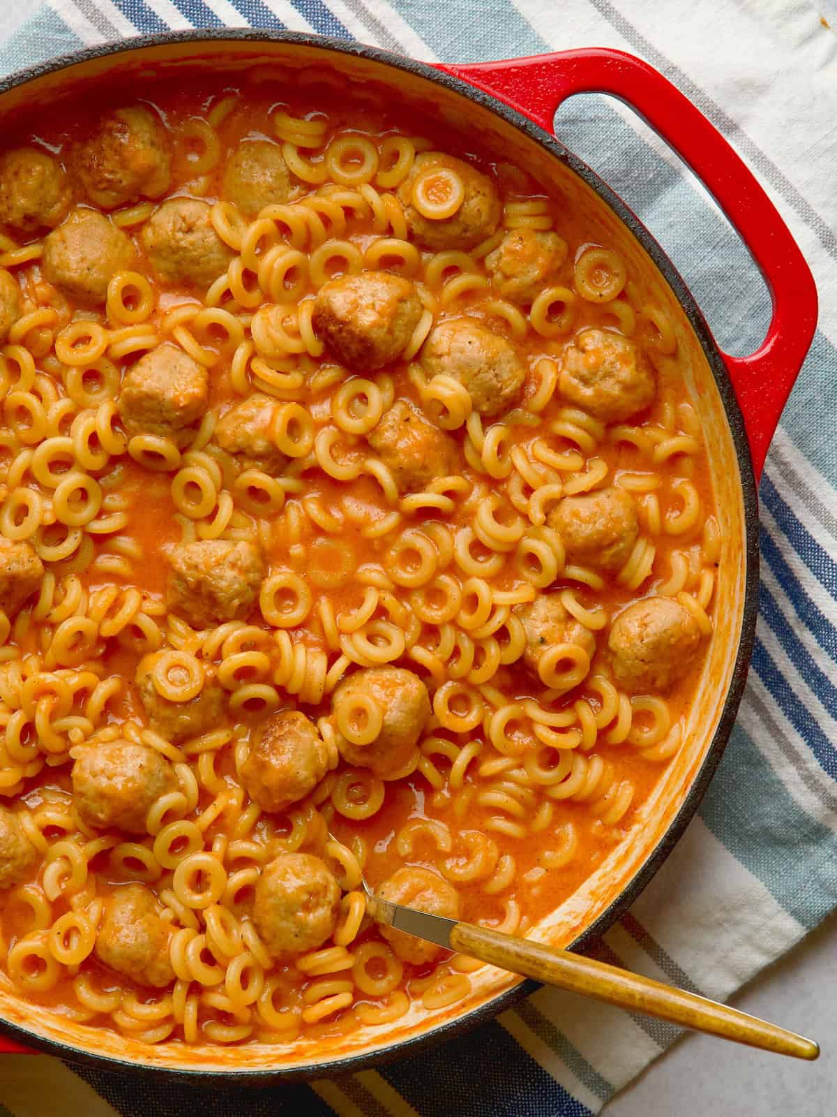 Spaghettios with meatballs in cast iron pan.