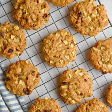 Apple and oat cookies on a wire rack.