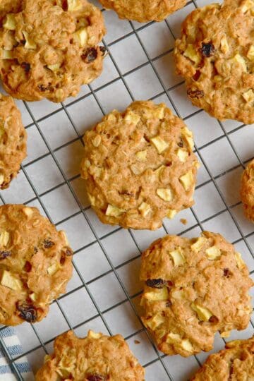 Apple and oat cookies on a wire rack.