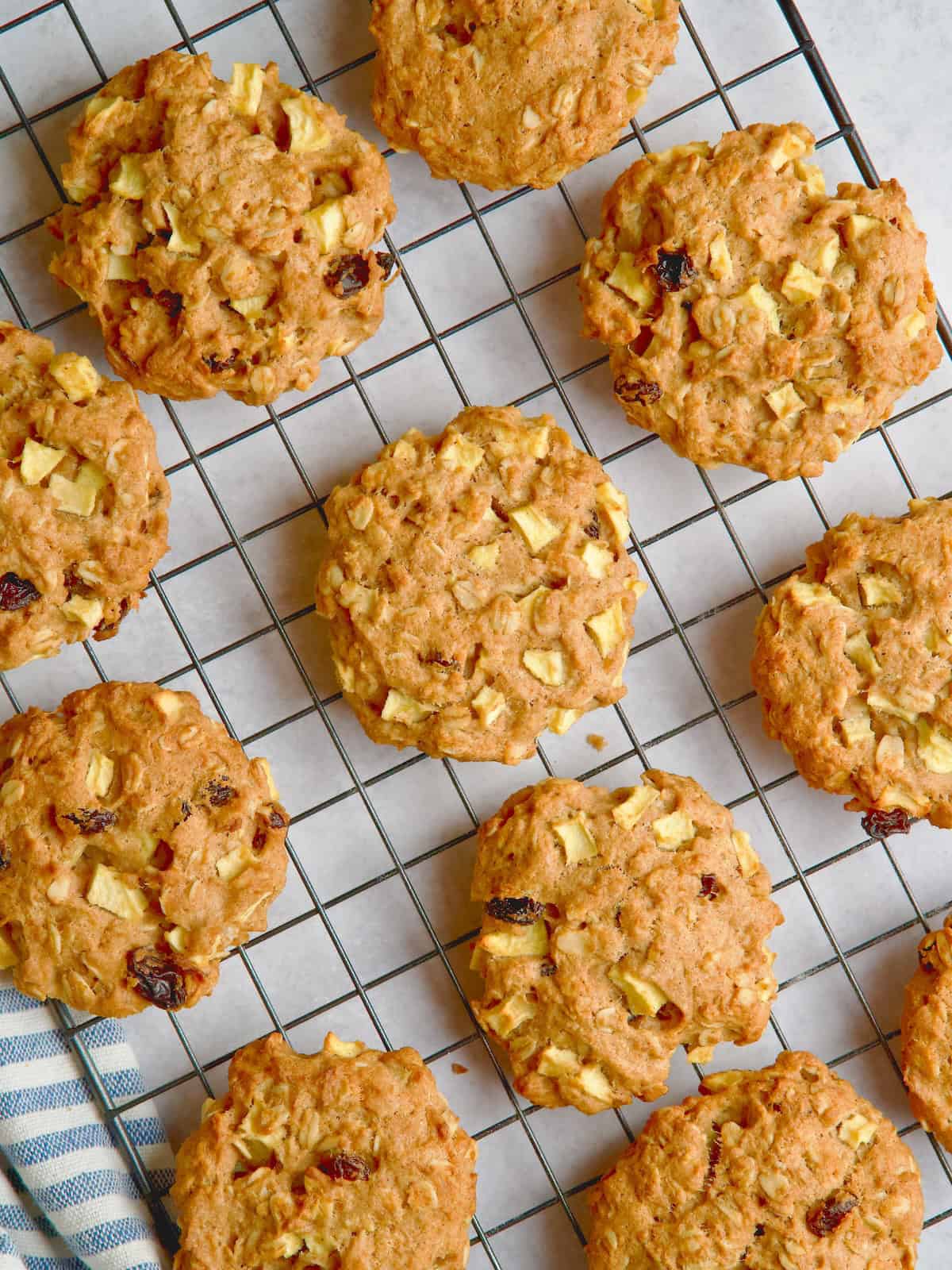 Apple and oat cookies on a wire rack.